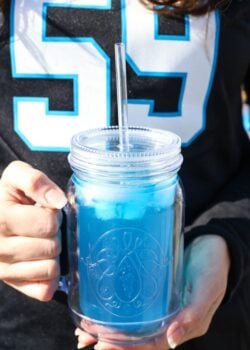 Carolina Panther Punch in front of Panthers jersey