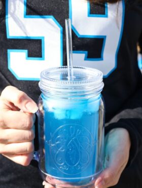 Carolina Panther Punch in front of Panthers jersey