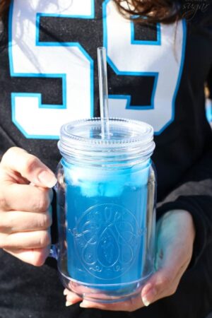 Carolina Panther Punch in front of Panthers jersey
