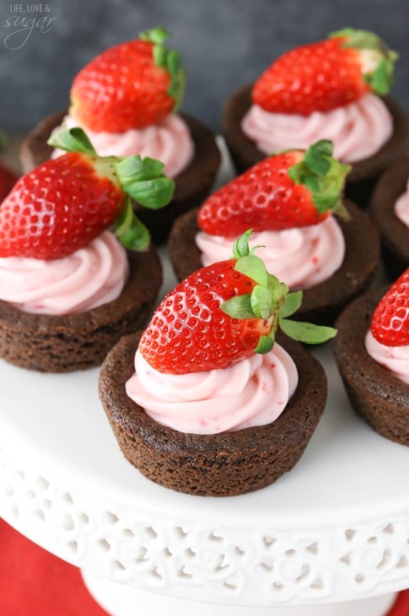 Overhead view of Strawberry Cheesecake Chocolate Cookie Cups on a white cake stand