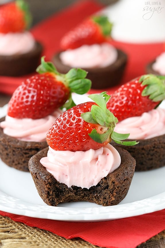 Close-up of Strawberry Cheesecake Chocolate Cookie Cups on a plate with a bite out of one