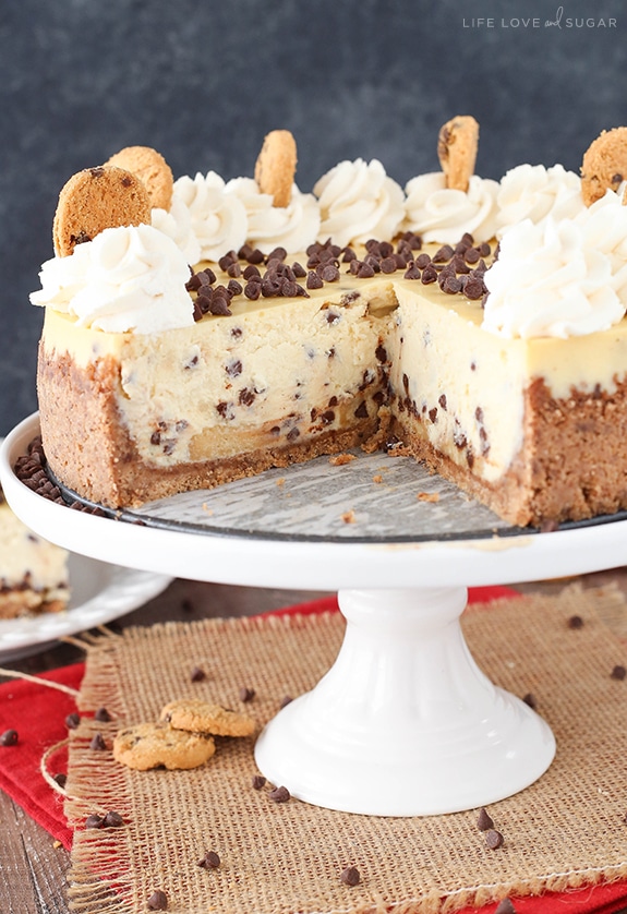 Chocolate Chip Shortbread Cheesecake on a cake stand with a slice removed