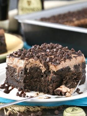 Guinness Chocolate Poke Cake slice on a plate with a bite taken out