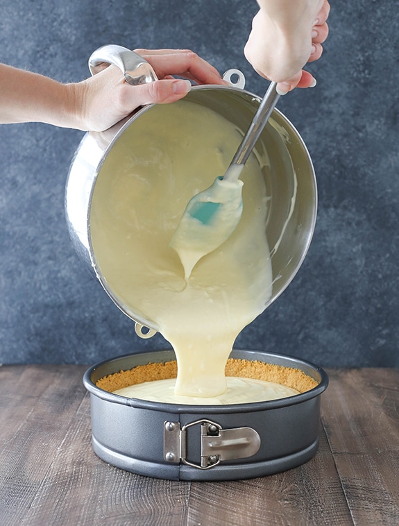Step 4 - add batter to pan - image of pouring cheesecake batter into prepared sringform pan