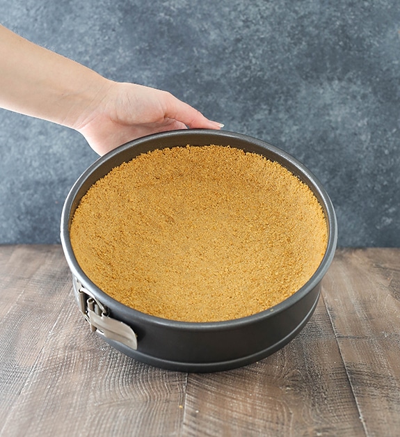 Step 3 - make and bake the crust - image of cheesecake crust in springform pan
