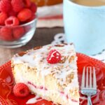 A slice of Raspberry Cream Cheese Coffee Cake on a red plate