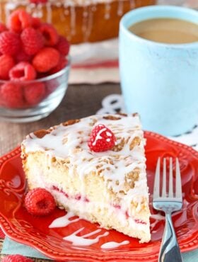 A slice of Raspberry Cream Cheese Coffee Cake on a red plate