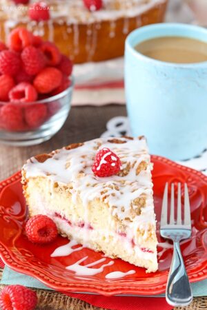 A slice of Raspberry Cream Cheese Coffee Cake on a red plate