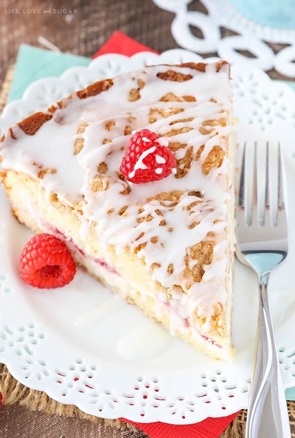 close up of Raspberry Cream Cheese Coffee Cake on white doily plate