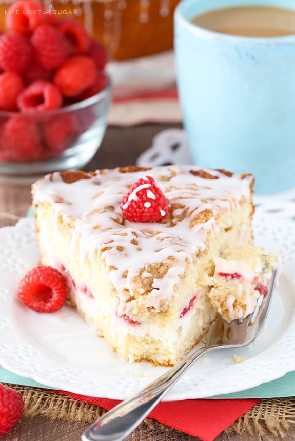 slice of Raspberry Cream Cheese Coffee Cake on a plate with a bite on a fork