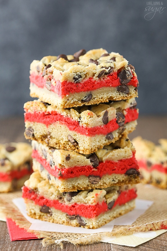 Red Velvet Cheesecake Chocolate Chip Cookie Bars - Chewy chocolate chip cookie surrounds red velvet cheesecake! Easy to make and great for Valentines Day!