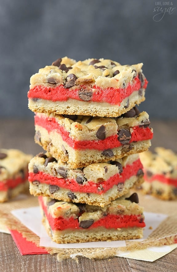 Red Velvet Cheesecake Chocolate Chip Cookie Bars - Chewy chocolate chip cookie surrounds red velvet cheesecake! Easy to make and great for Valentines Day!
