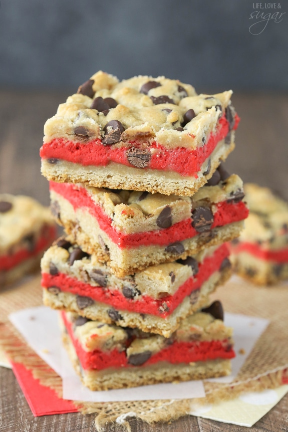 Red Velvet Cheesecake Chocolate Chip Cookie Bars - Chewy chocolate chip cookie surrounds red velvet cheesecake! Easy to make and great for Valentines Day!