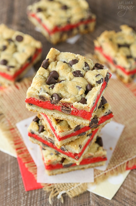 Red Velvet Cheesecake Chocolate Chip Cookie Bars - Chewy chocolate chip cookie surrounds red velvet cheesecake! Easy to make and great for Valentines Day!