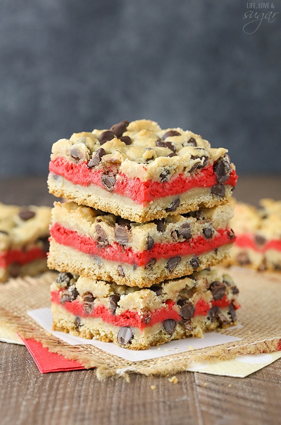 Red Velvet Cheesecake Chocolate Chip Cookie Bars - Chewy chocolate chip cookie surrounds red velvet cheesecake! Easy to make and great for Valentines Day!