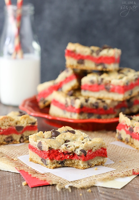 Red Velvet Cheesecake Chocolate Chip Cookie Bars - Chewy chocolate chip cookie surrounds red velvet cheesecake! Easy to make and great for Valentines Day!