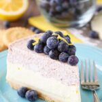 Slice of Lemon Blueberry Mousse cake on a blue plate