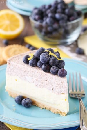 Slice of Lemon Blueberry Mousse cake on a blue plate