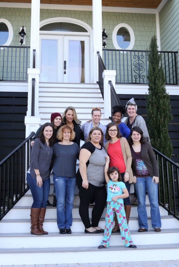 A group of bloggers posing on the front steps of a house for the blogger retreat