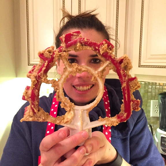 Julianne holding a stand mixer paddle with batter on it