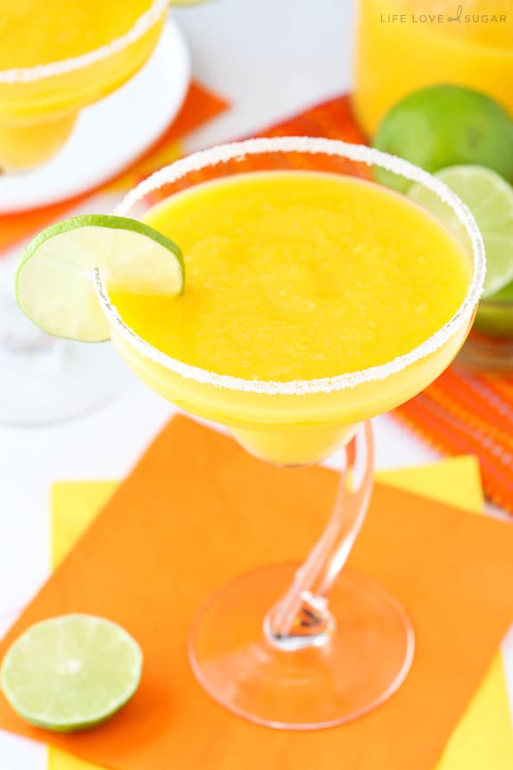 Frozen Mango Margaritas garnished with a lime slice