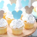 Mickey Mouse Themed Cupcakes with White Frosting and Sprinkles on a Cake Stand