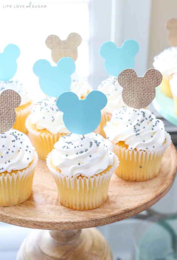 Mickey Mouse Themed Cupcakes with White Frosting and Sprinkles on a Cake Stand