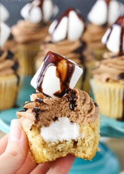 A hand holding a Nutella Fluffernutter Cupcake with a bite taken out