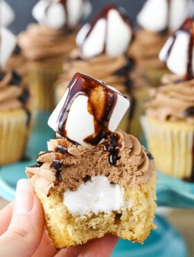 A hand holding a Nutella Fluffernutter Cupcake with a bite taken out