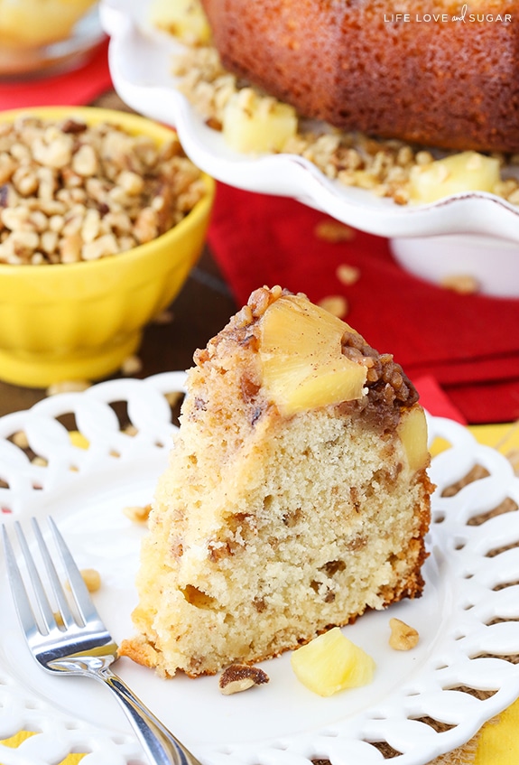 A slice of Pineapple Walnut Upside Down Bundt Cake on a white plate with a fork