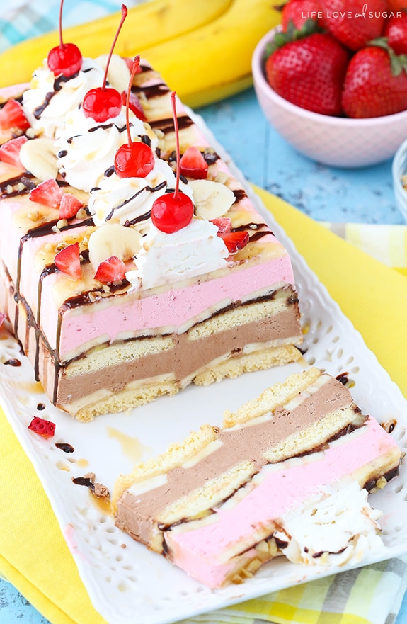 Banana Split Ice Cream Cake Loaf on a platter with a slice cut