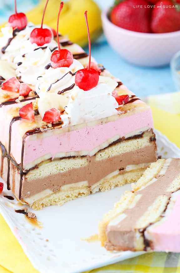 Banana Split Ice Cream Cake Loaf on a platter with a slice cut