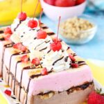 Fully decorated Banana Split Ice Cream Cake Loaf on a platter