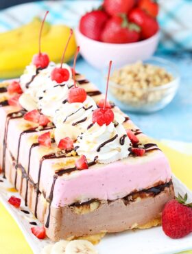 Fully decorated Banana Split Ice Cream Cake Loaf on a platter