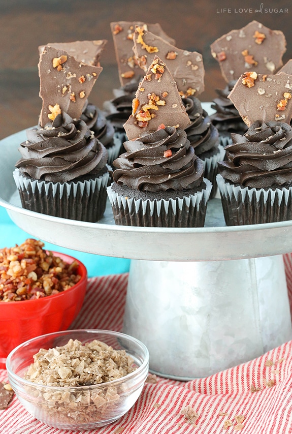 Smokey Bourbon Chocolate Cupcakes with Bacon on a cake stand