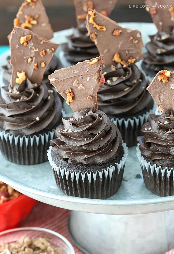 Smokey Bourbon Chocolate Cupcakes with Bacon on a cake stand