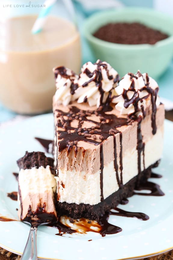A slice of Frozen Irish Cream Mousse Cake on a plate with a bite on a fork
