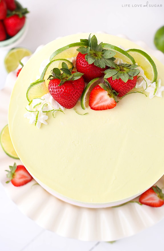 Overhead view of Key Lime Strawberry Coconut Ice Cream Cake topped with fresh strawberries and lime slices