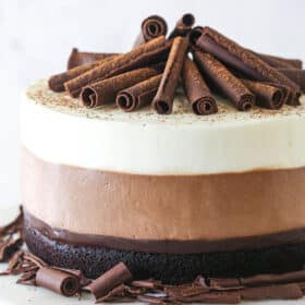 Triple chocolate mousse cake on a cake stand