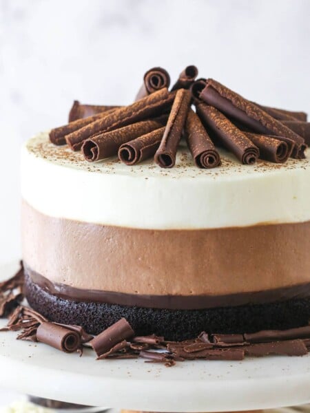 Triple chocolate mousse cake on a cake stand