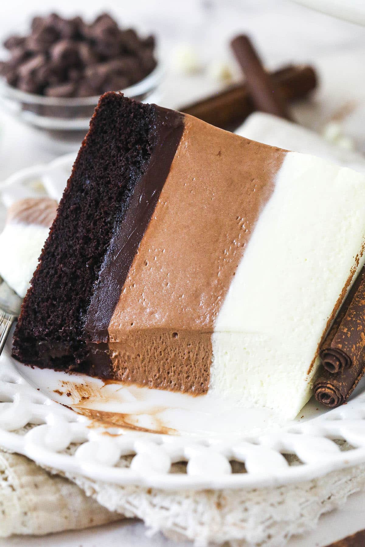 A plate with a slice of triple chocolate mousse cake