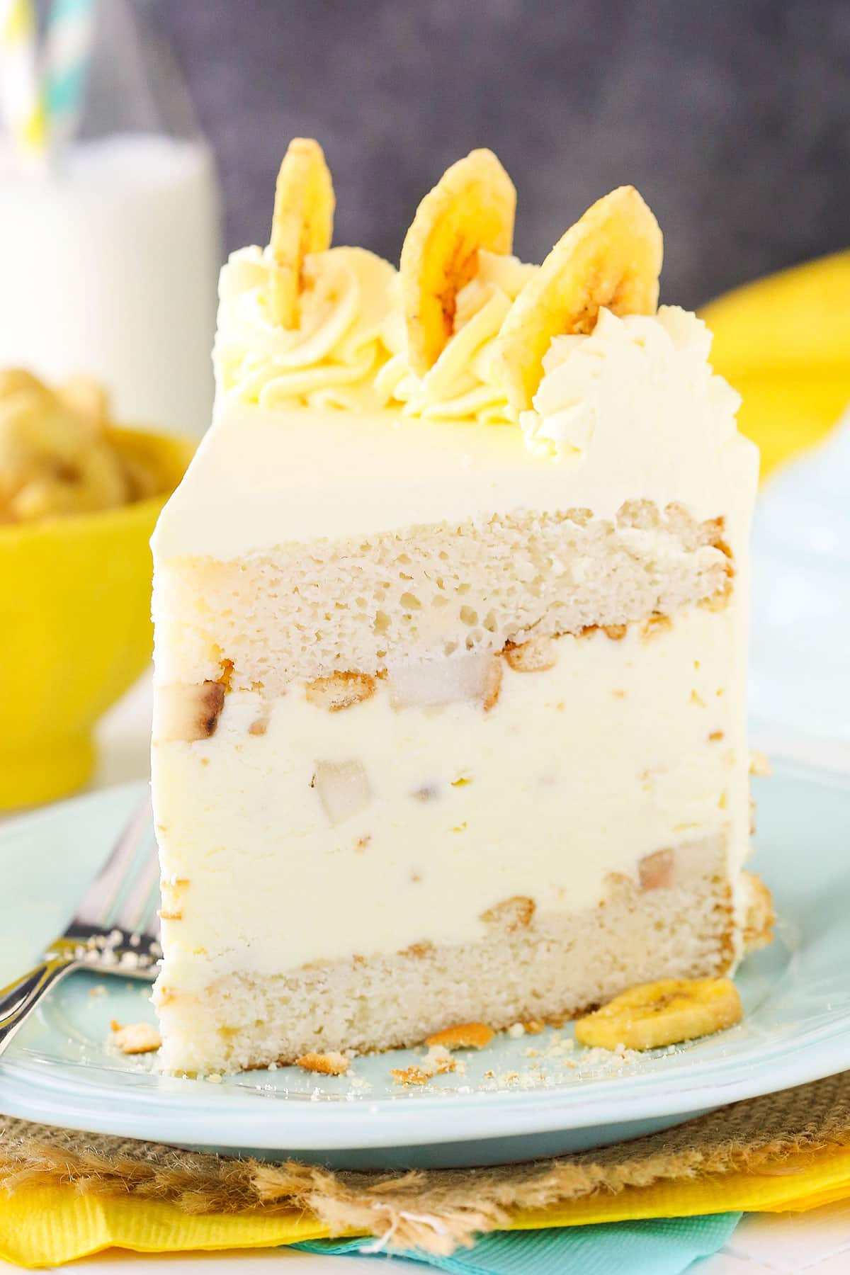 Slice of banana pudding ice cream cake with vanilla wafers.