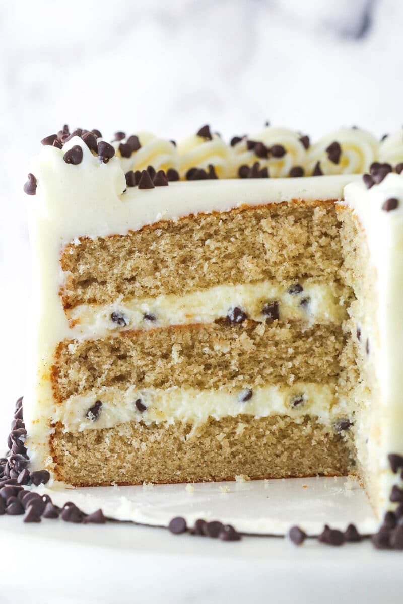 Light, moist cinnamon cakes are layered with cannoli filling and mascarpone frosting in this Cannoli Layer Cake. Cannoli layer cake with a slice missing