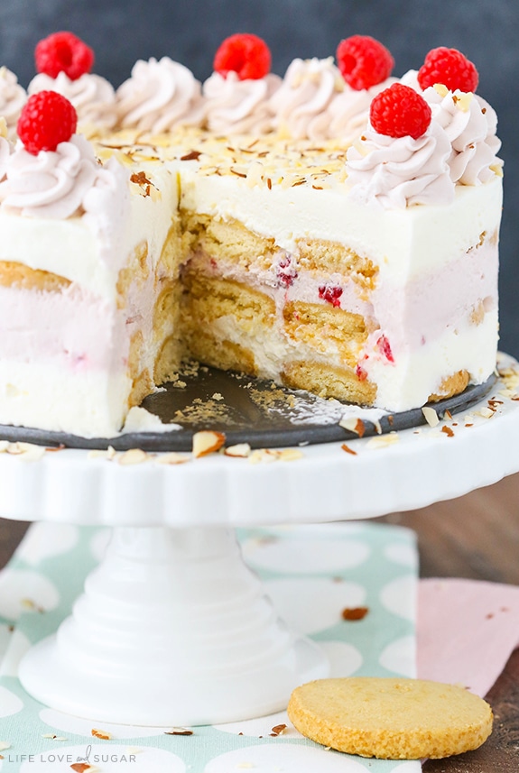 Raspberry Almond Shortbread Icebox Cake on a cake stand with a slice removed