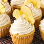 Close up of an Apple Butter Cupcake with an apple chip in the frosting on cooling rack