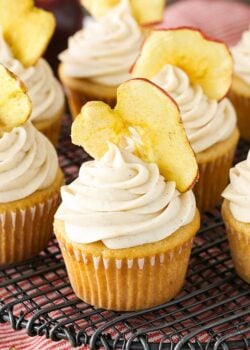 Close up of an Apple Butter Cupcake with an apple chip in the frosting on cooling rack