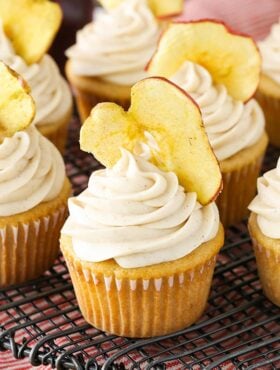 Close up of an Apple Butter Cupcake with an apple chip in the frosting on cooling rack