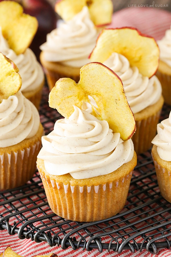 Close up of an Apple Butter Cupcake with an apple chip in the frosting on cooling rack