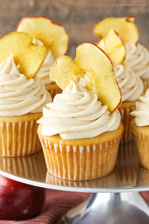 Apple Butter Cupcakes on a silver cake stand with apple chips in the frosting