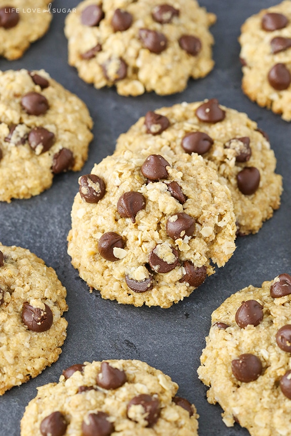 Oatmeal Chocolate Chip Cookies loaded with chocolate laid out on a dark surface 